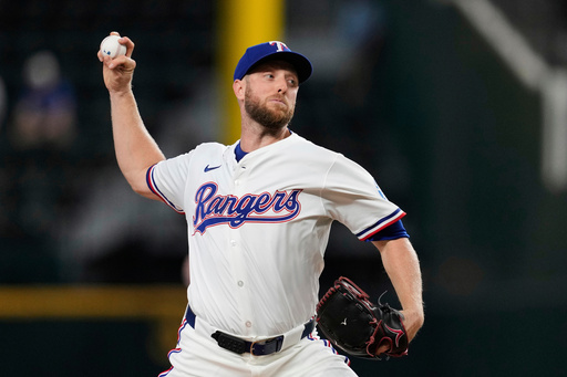 FILE - Texas Rangers starting pitcher Merrill Kelly throws to the Arizona Diamondbacks in the first inning of a baseball game, Aug. 13, 2025, in Arlington, Texas. (AP Photo/Tony Gutierrez, File)