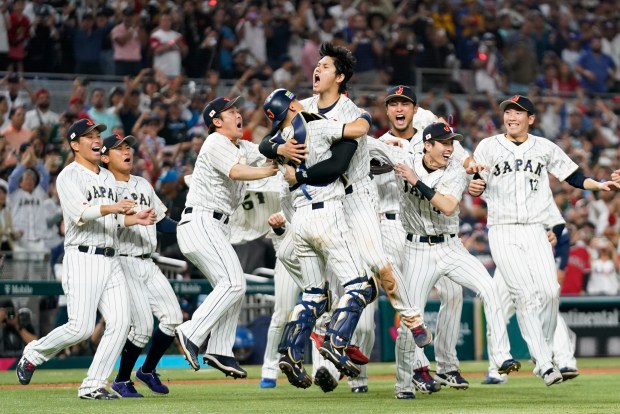 FILE - Japan player Shohei Ohtani (16) celebrates with his teammates after defeating the United States in the World Baseball Classic championship game, Tuesday, March 21, 2023, in Miami. (AP Photo/Wilfredo Lee, File)