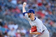 Texas Rangers relief pitcher Chris Martin throws during the ninth inning of a baseball game...