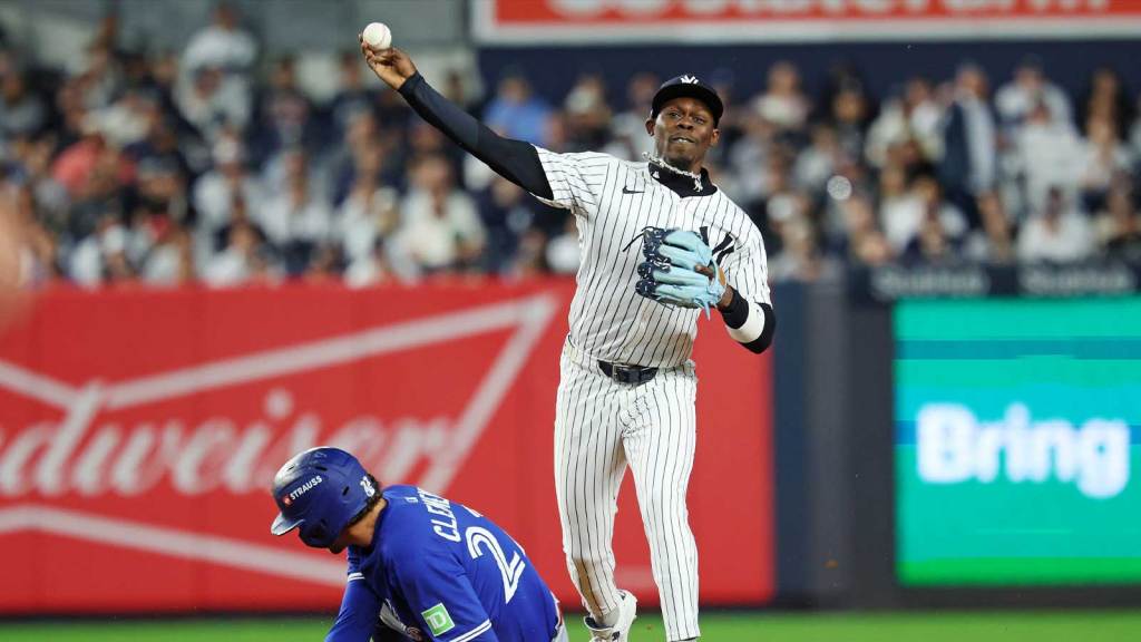 New York Yankees second baseman Jazz Chisholm Jr. (13) forces out Toronto Blue Jays third baseman Ernie Clement (22) and tries to turn a double play during the eighth inning during game four of the ALDS round for the 2025 MLB playoffs at Yankee Stadium.