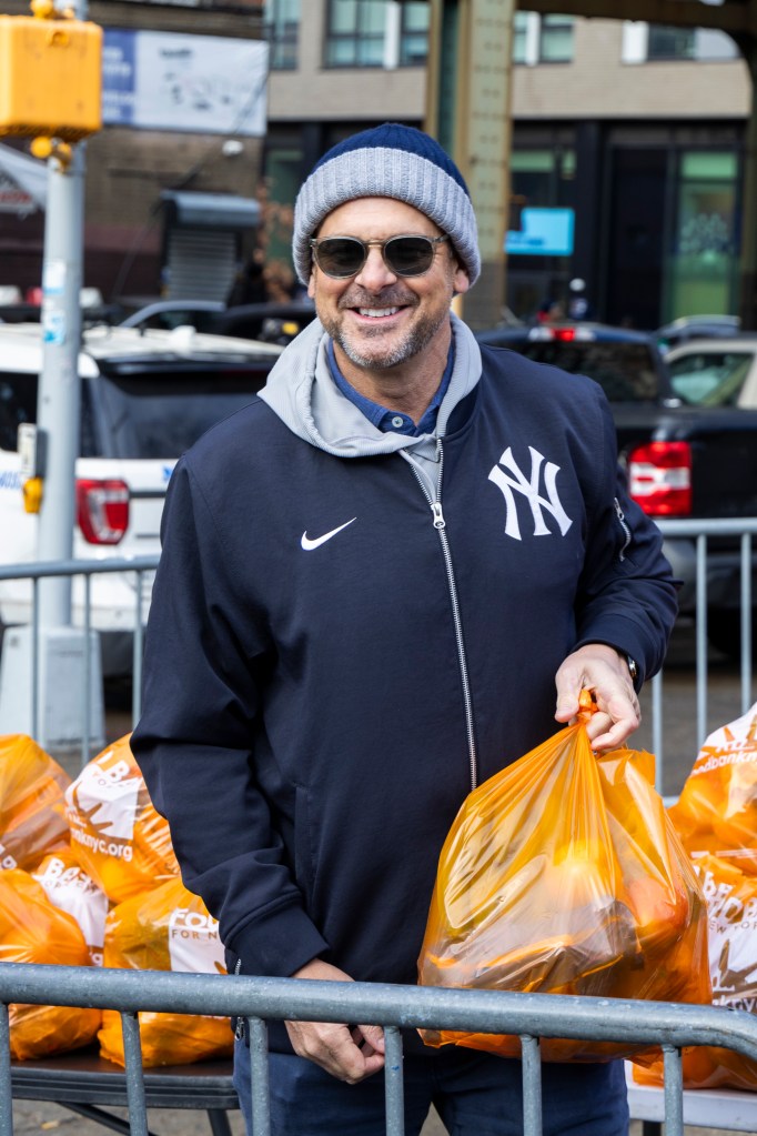 New York Yankees manager Aaron Boone, the 44th precinct and the Food Bank of New York City are distributing food and toys to 500 neighborhood families, Friday, Dec. 19, 2025, in Bronx, NY. 