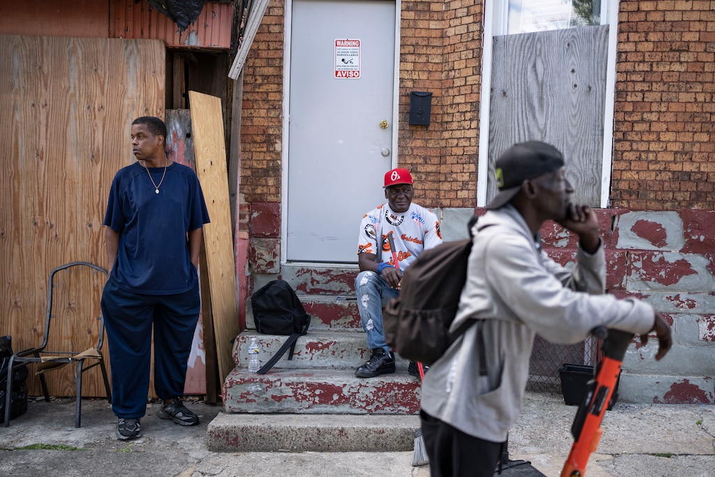 Left to right, Clarence Coleman, Leonard “Bo” White, and Darrell F. hang out next to Big O’s Hand Car Wash, in Baltimore, Friday, August 8, 2025.