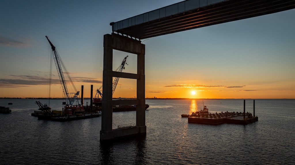 Crane barges are seen at the Francis Scott Key Bridge site at sunrise as test piles are installed into the Patapsco River bed to test the strength and stability for the new bridge's foundation.