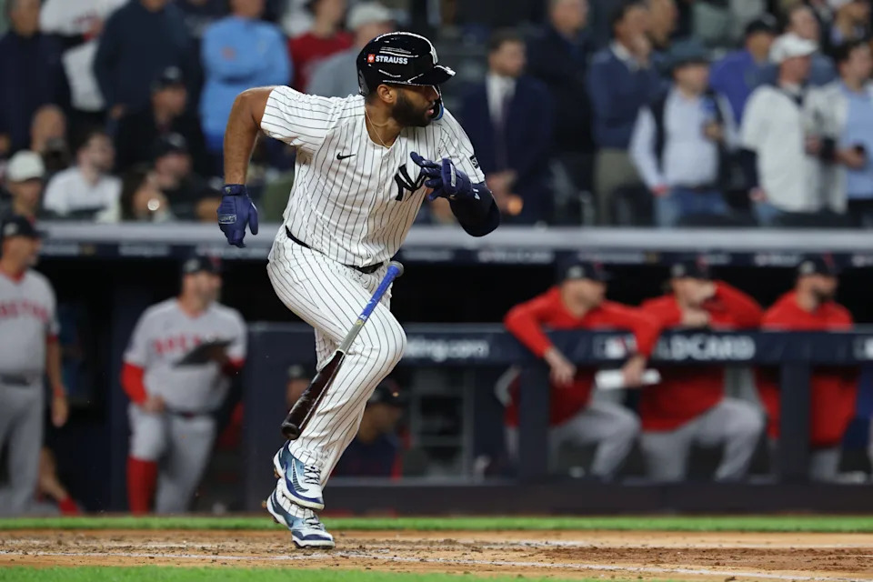 Oct 2, 2025; Bronx, New York, USA; New York Yankees third baseman Amed Rosario (14) hits an RBI single in the fourth inning against the Boston Red Sox during game three of the Wildcard round for the 2025 MLB playoffs at Yankee Stadium. Mandatory Credit: Vincent Carchietta-Imagn Images