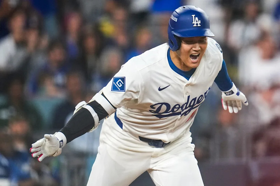 Los Angeles Dodgers designated hitter Shohei Ohtani (17) celebrates as he runs for first on an RBI single in the sixth inning of the MLB National League Wild Card Game 2 between the Los Angeles Dodgers and the Cincinnati Reds at Dodger Stadium in Los Angeles on Wednesday, Oct. 1.