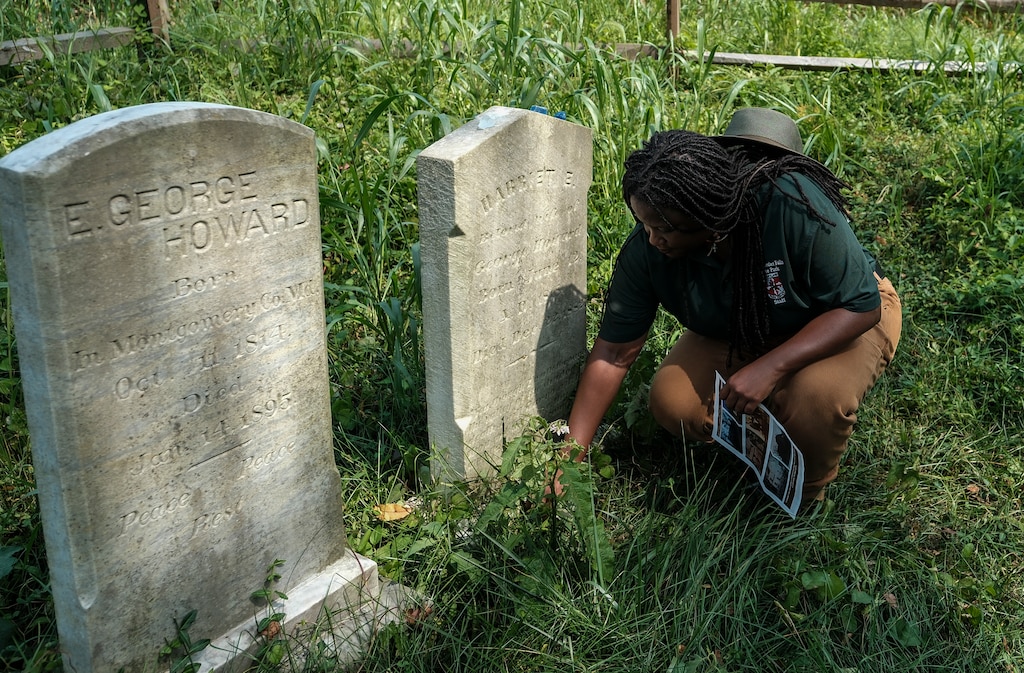Maryland State Park Service Superintendent Angela Crenshaw pays respect at a headstone during a tour Patuxent River Park in Montgomery County on August 7, 2025. The state of Maryland is currently working on a project for Freedmen’s State Park, to tell the story of Enoch George Howard, his family and, more broadly, enslaved Marylanders.