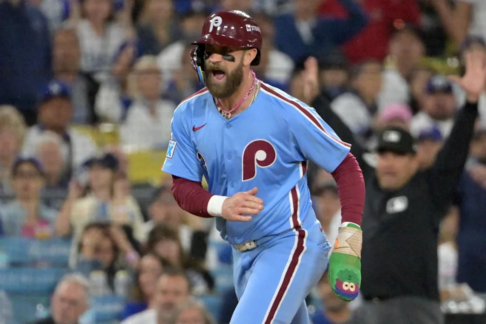 Phillies first baseman Bryce Harper reacts as he scores a run during the fourth inning in game three of the NLDS against the Los Angeles Dodgers during the 2025 MLB playoffs. IMAGN IMAGES via Reuters Connect
