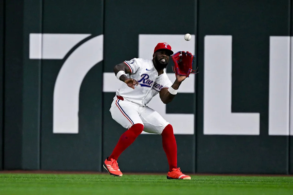 Aug 5, 2024; Arlington, Texas, USA; Texas Rangers right fielder Adolis Garcia (53) catches a fly ball hit by Houston Astros third baseman Alex Bregman (not pictured) during the sixth inning at Globe Life Field. Mandatory Credit: Jerome Miron-Imagn Images