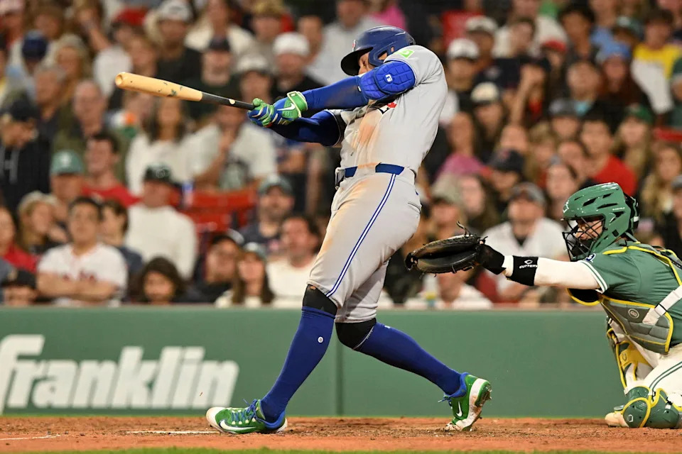 Jun 27, 2025; Boston, Massachusetts, USA; Toronto Blue Jays right fielder George Springer (4) hits a RBI single against the Boston Red Sox during the eighth inning at Fenway Park. (Brian Fluharty/Imagn Images)