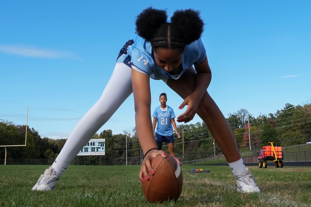 Rahel Ambaye and Julia Cruz practice ahead of their flag football match between Seneca Valley High School and Clarksburg High School at Clarksburg High School in Clarksburg, Maryland, U.S., Oct. 15, 2025.