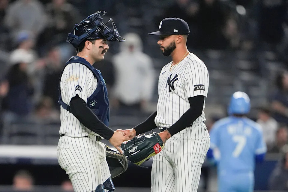 Apr 14, 2025; Bronx, New York, USA; New York Yankees catcher Austin Wells (28) and pitcher Devin Williams (38) shake hands to celebrate the victory after the game against the Kansas City Royals at Yankee Stadium. Mandatory Credit: Gregory Fisher-Imagn Images