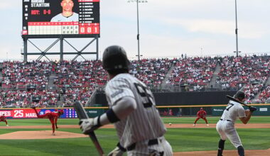 A Yankee batter swings at a baseball thrown by the Mexico City Diablos Rojos pitcher in Alfredo Harp Helú Stadium