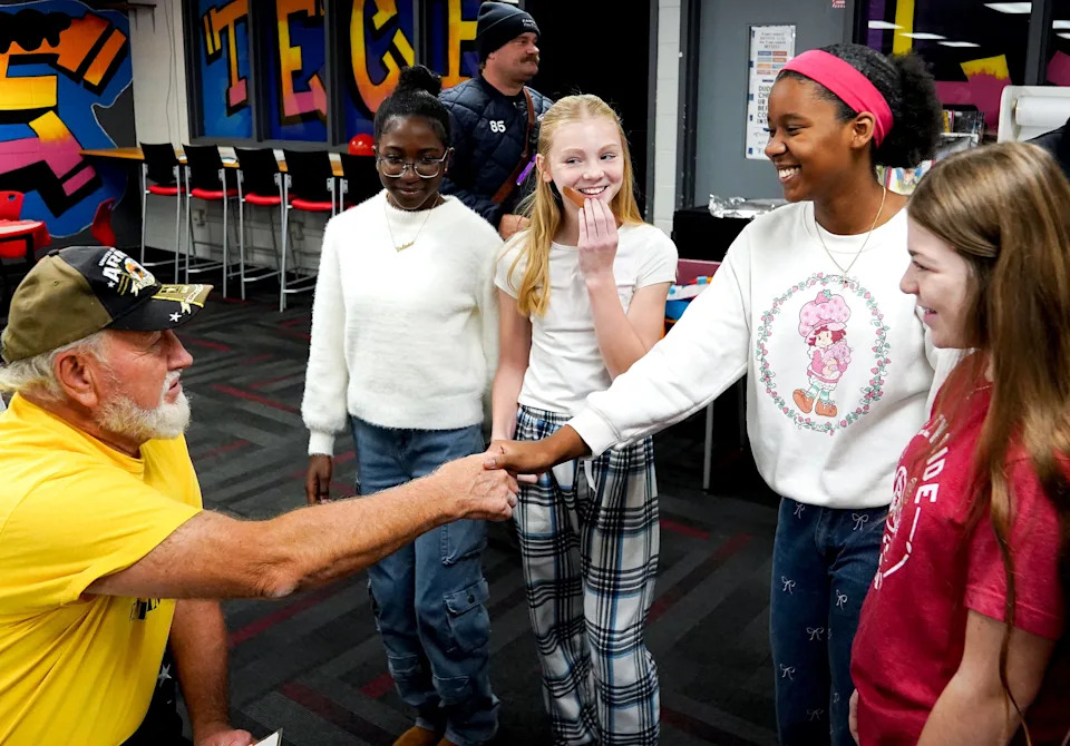 Vietnam Veteran Raymond Beck, 80, of American Legion Post 513, left, greets students during the Veterans Day program, Tuesday, Nov. 11, 2025, at Creekside Middle School in Fairfield, Oh.