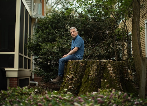 TAKOMA PARK, MD - APRIL 4:
Mike Tidwell sits on the stump of an oak tree, in a neighbor’s backyard on Willow Avenue in Takoma Park MD on April 4, 2025. Tidwell’s new book, The Lost Trees of Willow Avenue, talks about the diminishing oak trees and impacts of climate change on his neighborhood.