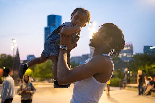 Monday, Aug. 4, 2025 — Keyva Bluitt holds his godson, Essan, 1, at Jake’s Skatepark in Baltimore City, Md.