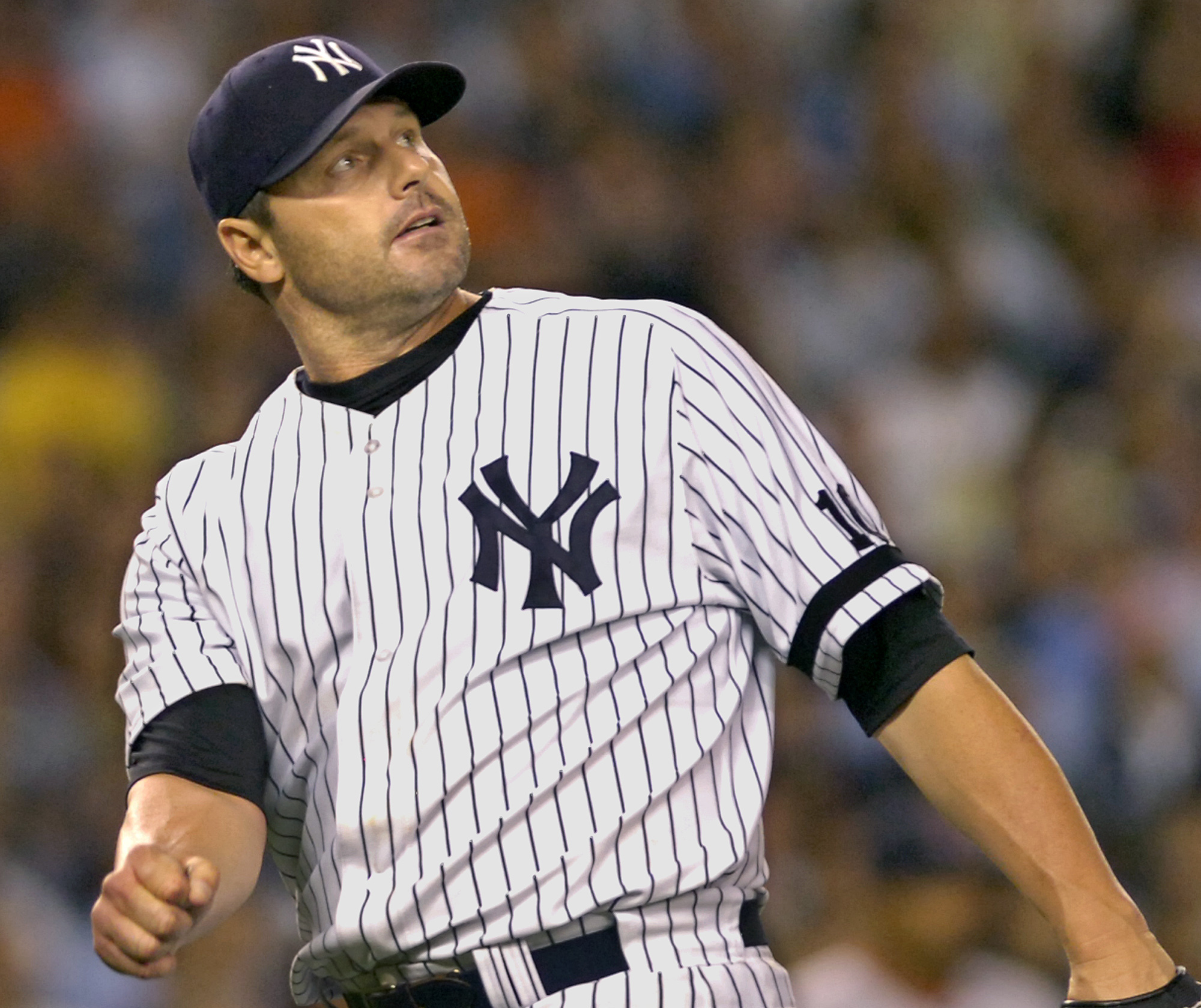 FILE – New York Yankees pitcher Roger Clemens watches a...
