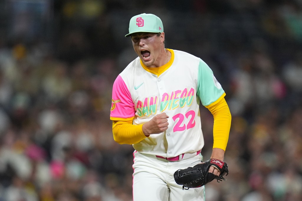 A San Diego Padres pitcher in a colorful uniform celebrates on the mound.