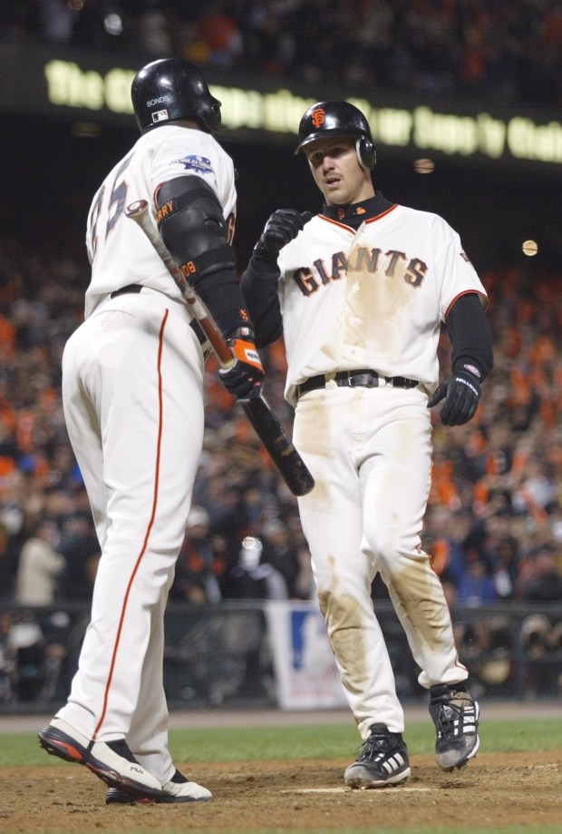 PHOTO BY MERI SIMON/SJMN 10/24/02 Jeff Kent is greeted by Barry Bonds after slamming a 2-run homer in the 6th inning. The homer made the score 8-4 to keep the Giants ahead of the Angels. Today was Game 5 of the World Series played at Pac Bell Park in San Francisco.