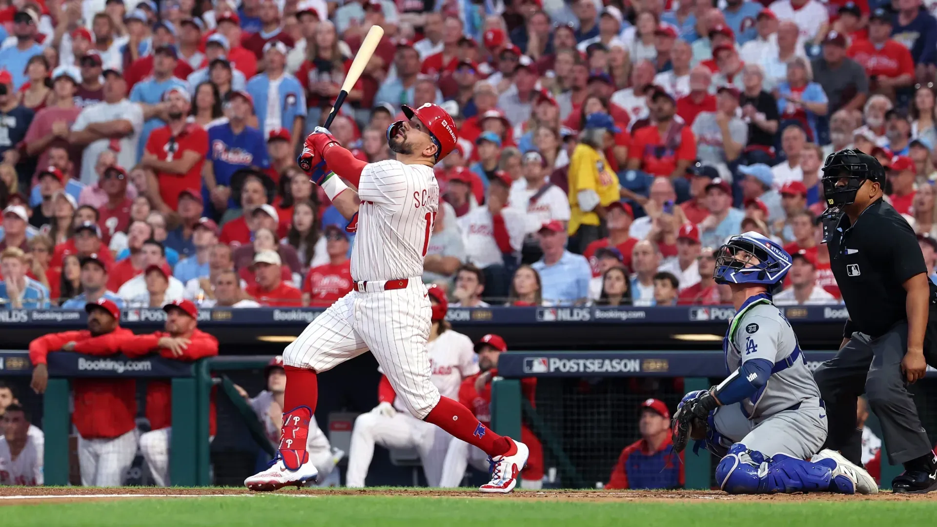 Kyle Schwarber #12 of the Phillies flies out against the Dodgers. Hunter Martin/Getty Images