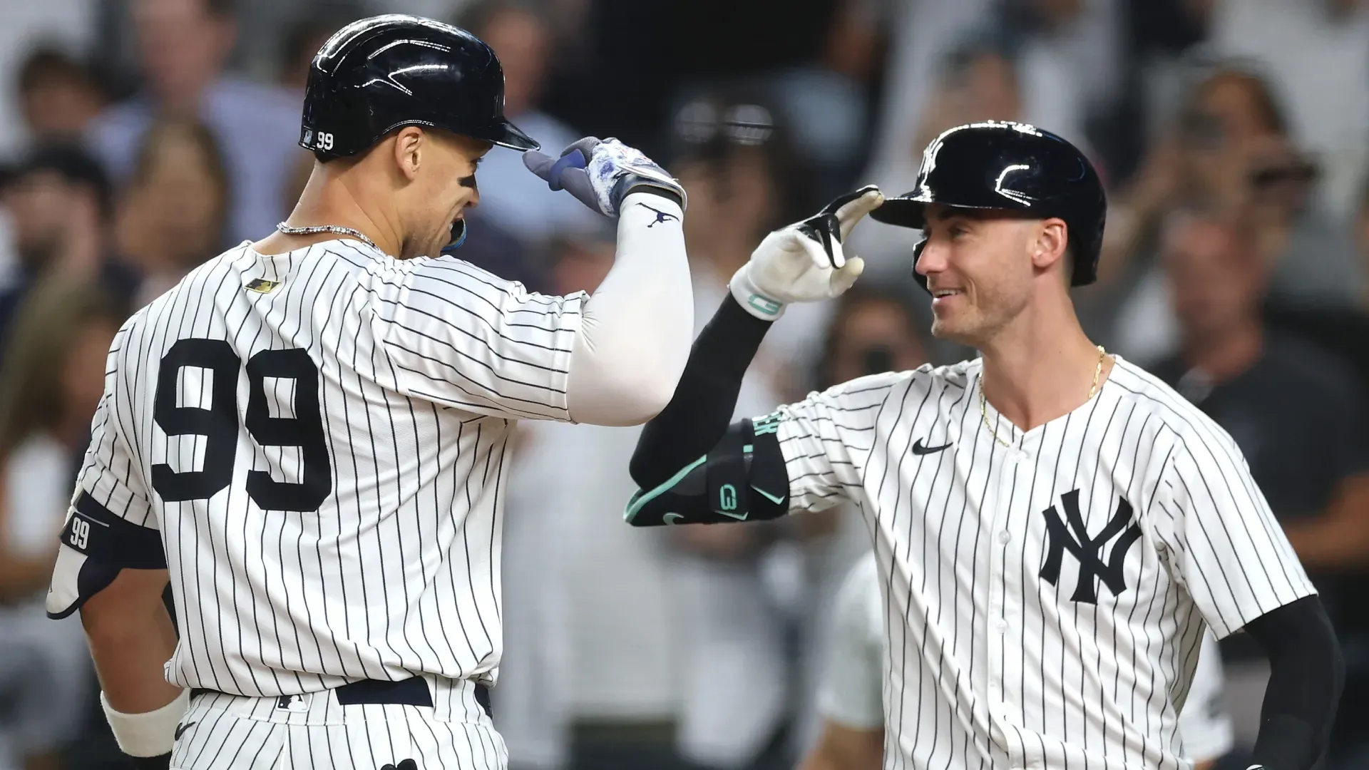 Aaron Judge #99 of the New York Yankees celebrates with Cody Bellinger #35 after hitting a home run. Ishika Samant/Getty Images