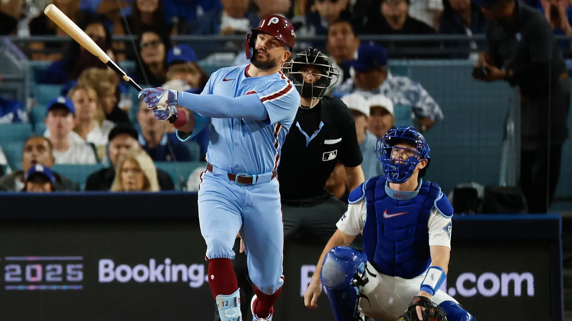 Kyle Schwarber #12 of the Phillies hits a solo home run against the Dodgers. Harry How/Getty Images