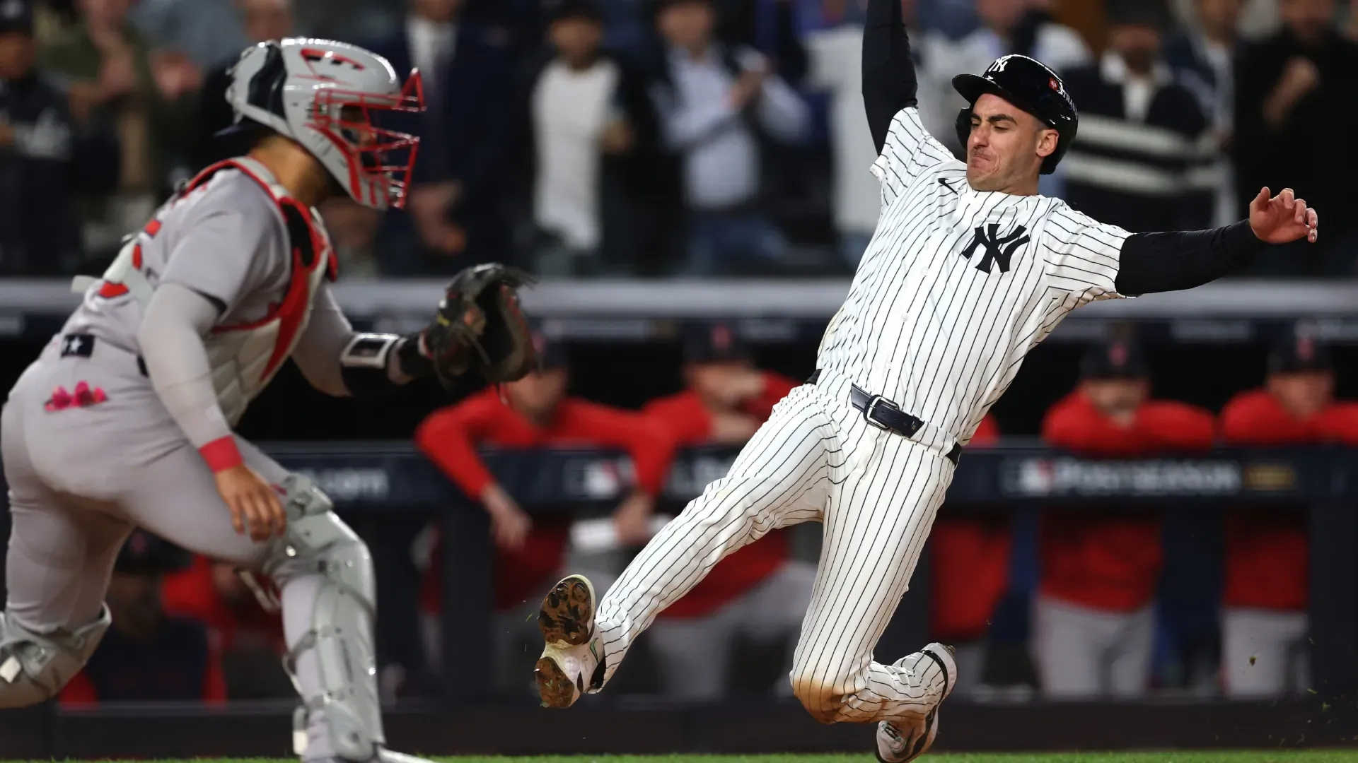 Cody Bellinger #35 of the New York Yankees slides into home plate to score a run. Ishika Samant/Getty Images
