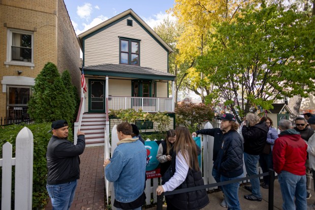 Visitors line up to enter the birthplace home of Walt Disney at the corner of North Tripp Avenue and West Palmer Street in Hermosa on Oct. 15, 2023, during Open House Chicago. Disney was born on the second floor in 1901 and grew up there until his family moved to Missouri in 1906. (Brian Cassella/Chicago Tribune)