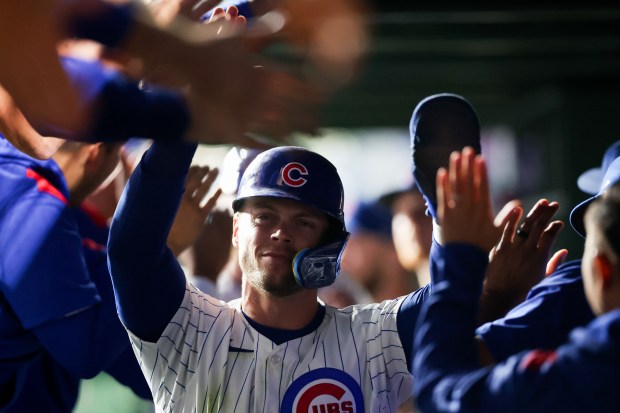 Chicago Cubs second base Nico Hoerner (2) celebrates in the dugout after scoring off a two RBI double from Chicago Cubs first base Carlos Santana (41) during the first inning at Wrigley Field Tuesday Sept. 23, 2025, in Chicago. (Armando L. Sanchez/Chicago Tribune)