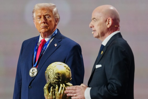 President Donald Trump receives the FIFA Peace Prize from FIFA President Gianni Infantino during the draw for the 2026 World Cup on Friday, Dec. 5, 2025, at the Kennedy Center in Washington. (Jia Haocheng/Pool Photo via AP)
