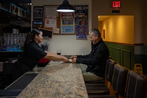 Server Brenda Ramirez serves regular customer Marco Cardenas his lunch at the bar of the El Golfo Restaurant in Silver Spring, MD, on Friday, October 10, 2025.