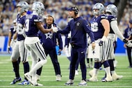 Dallas Cowboys head coach Brian Schottenheimer (right) slaps hands with wide receiver George...