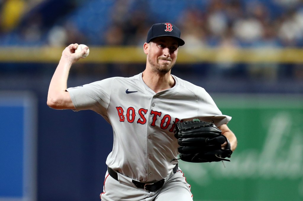 Boston Red Sox pitcher throwing a baseball.