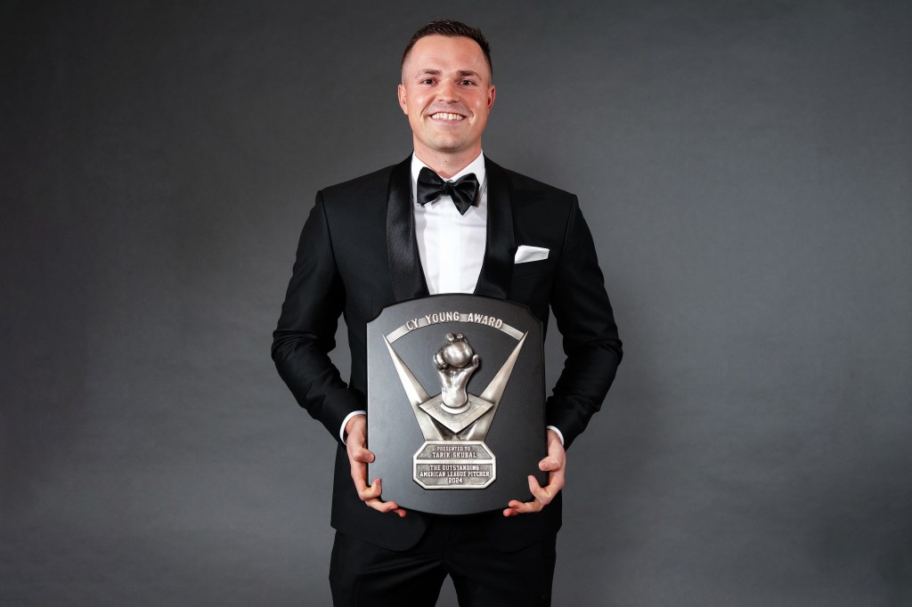 Taruk Skubal holding the Cy Young Award for Outstanding American League Pitcher.