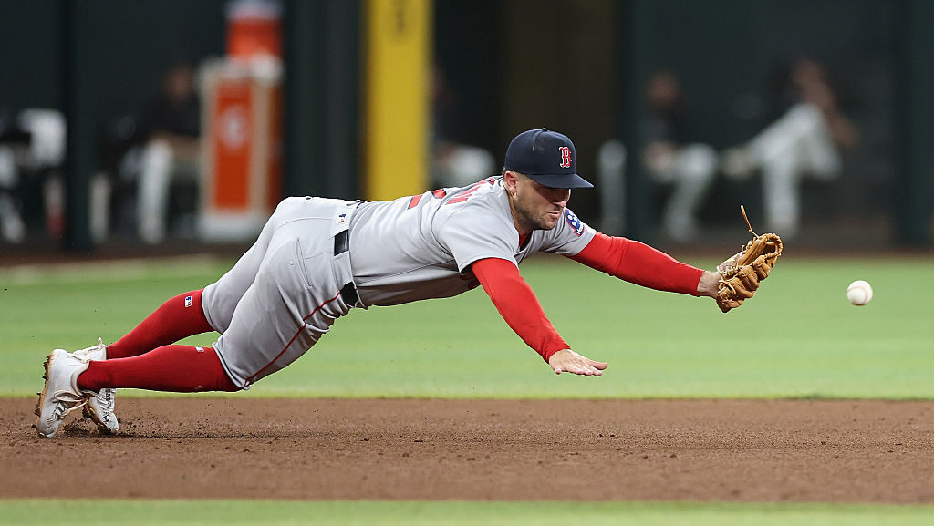 PHOENIX, ARIZONA - SEPTEMBER 06: Infielder Alex Bregman #2 of the Boston Red Sox attempts to field ...
