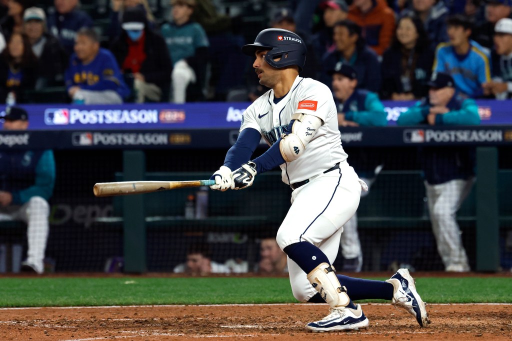 Harry Ford #5 of the Seattle Mariners hits a single during the ninth inning against the Toronto Blue Jays in game three of the American League Championship Series at T-Mobile Park on October 15, 2025 in Seattle, Washington. 