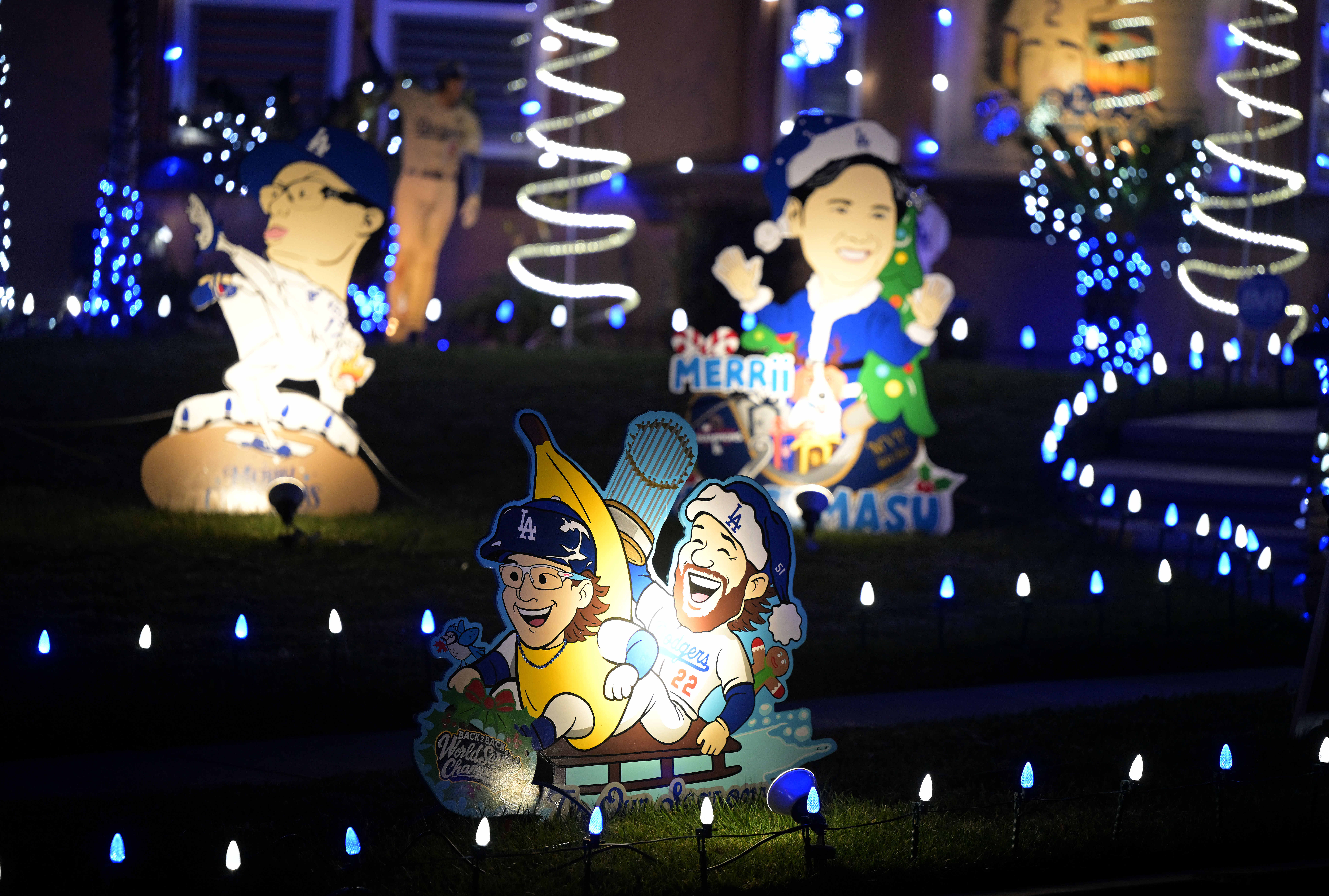 Los Angeles Dodgers-themed Christmas decorations fill the front yard of...