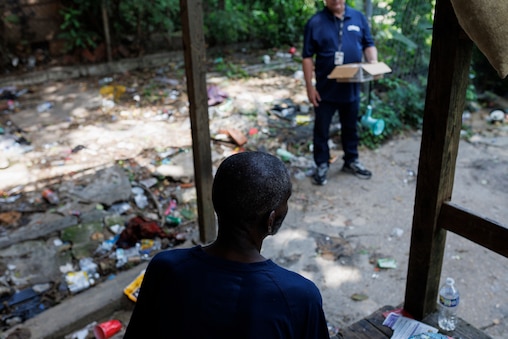 Bill Brooks, Chief Executive Officer at Penn North Recovery chats with Mark while doing community outreach on Friday, July 11, 2025 in Baltimore. Just a day following a mass-overdose in the area. Mark said he didn’t need Narcan today, and was grateful he wasn’t involved in the previous days casualties.