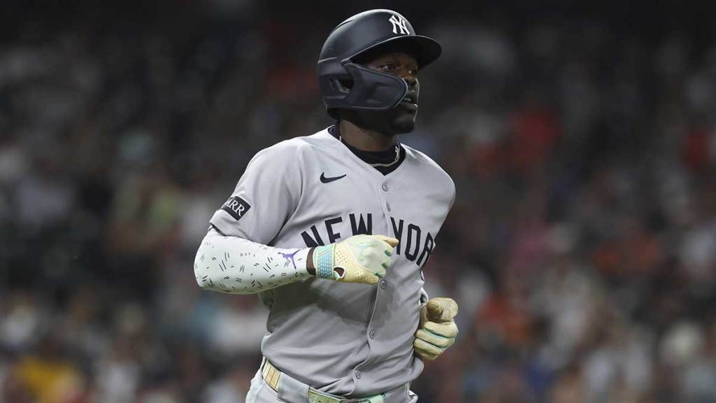 New York Yankees second baseman Jazz Chisholm Jr. (13) runs to first base on a single during the fifth inning against the Houston Astros at Daikin Park.