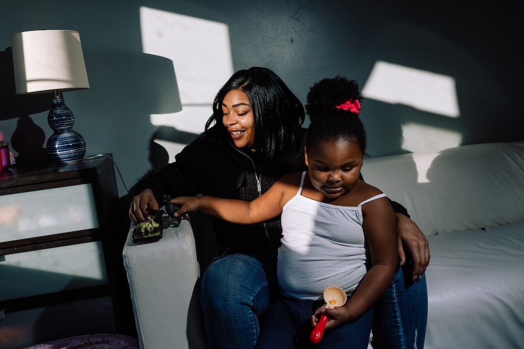 DECEMBER 4: Monique Polley plays with toy dinosaurs with her daughter, Aniyah, 4, in her mother’s home, in Baltimore, MD on Thursday, Dec. 4, 2025.