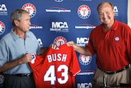 Former President George W. Bush accepts a jersey from owner Tom Hicks Thursday night at the...
