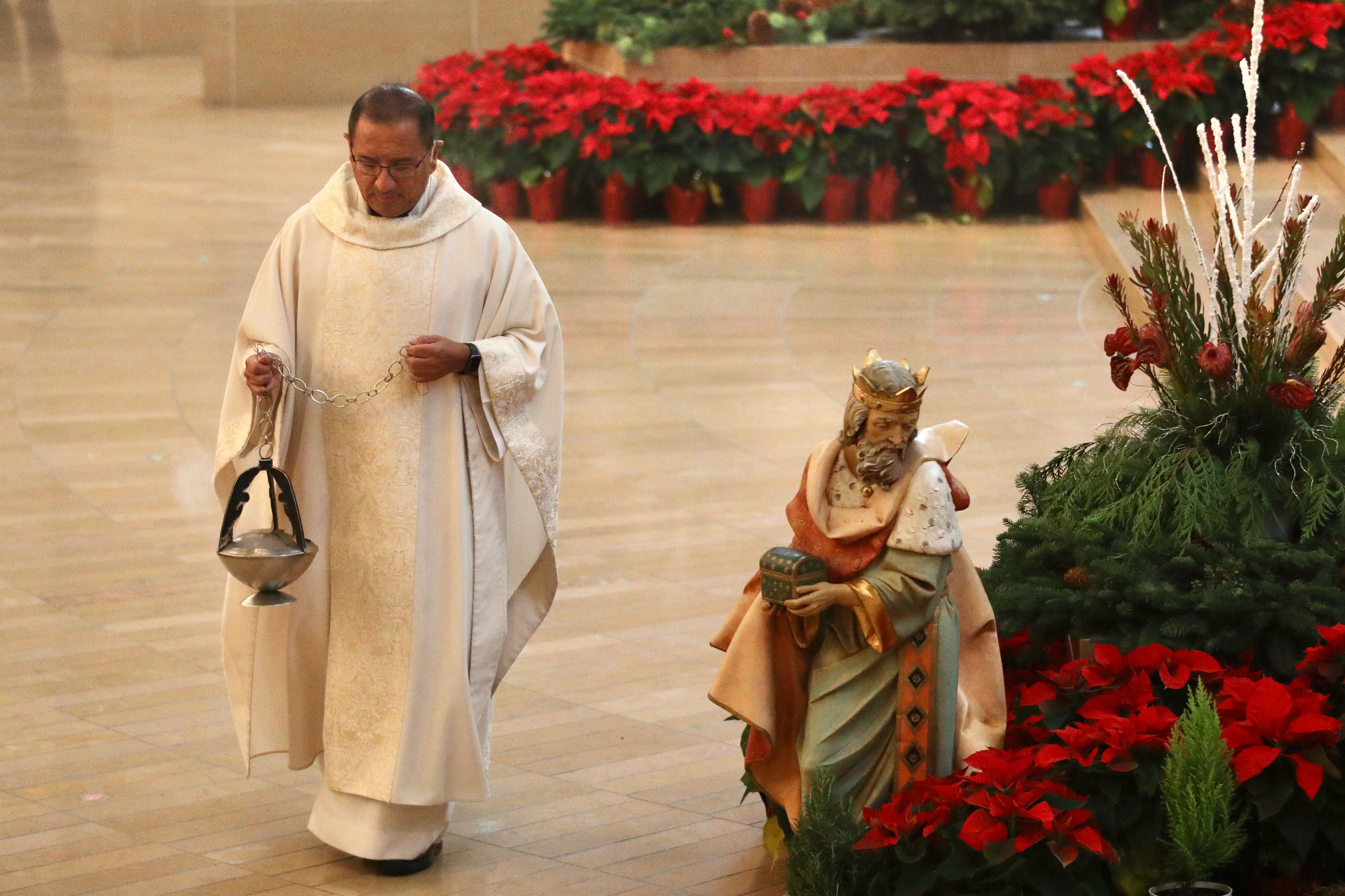 The Rev. David Gallardo presides over Christmas Day Mass at...
