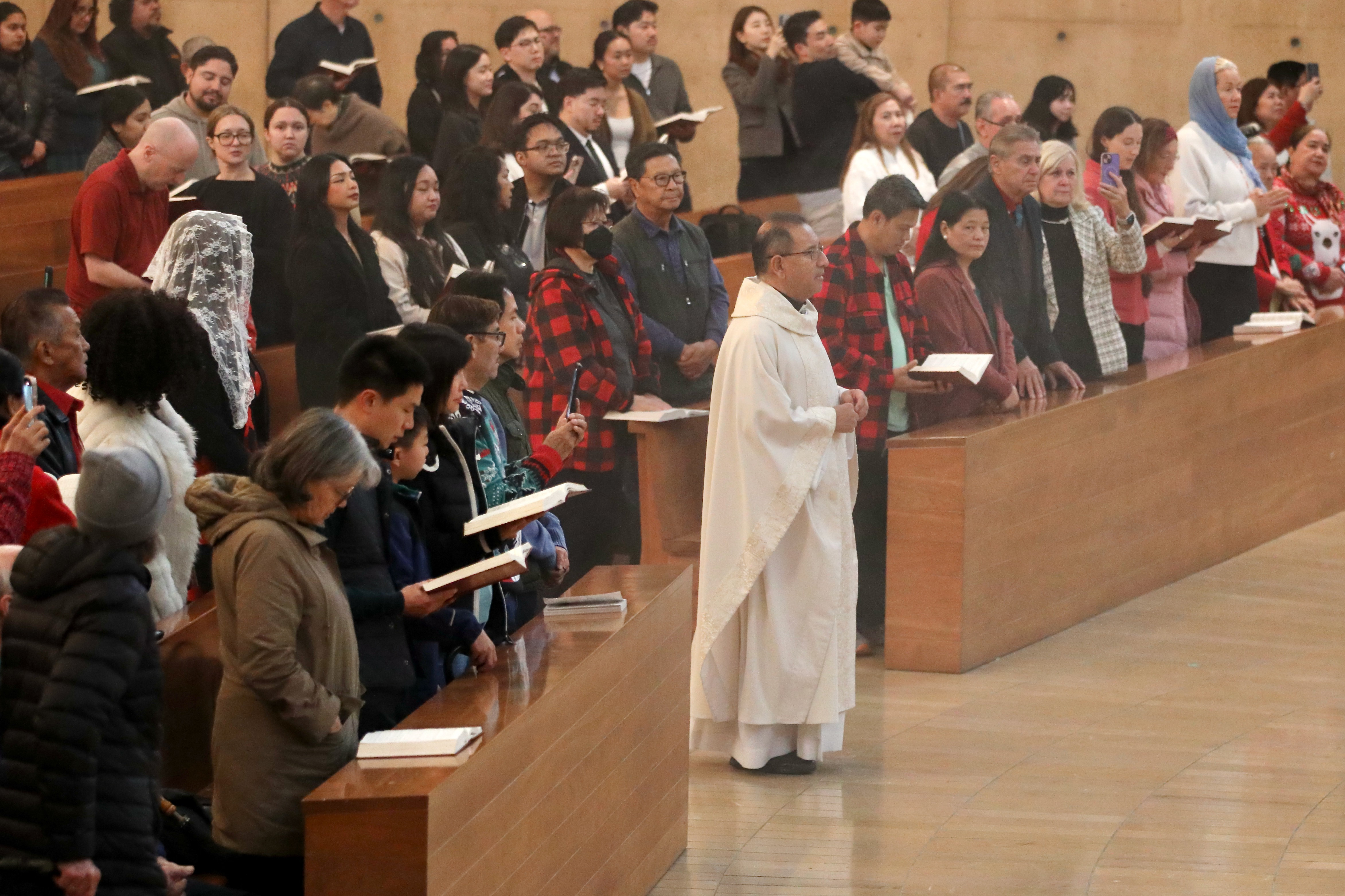 The Rev. David Gallardo enters to lead Christmas Day Mass...