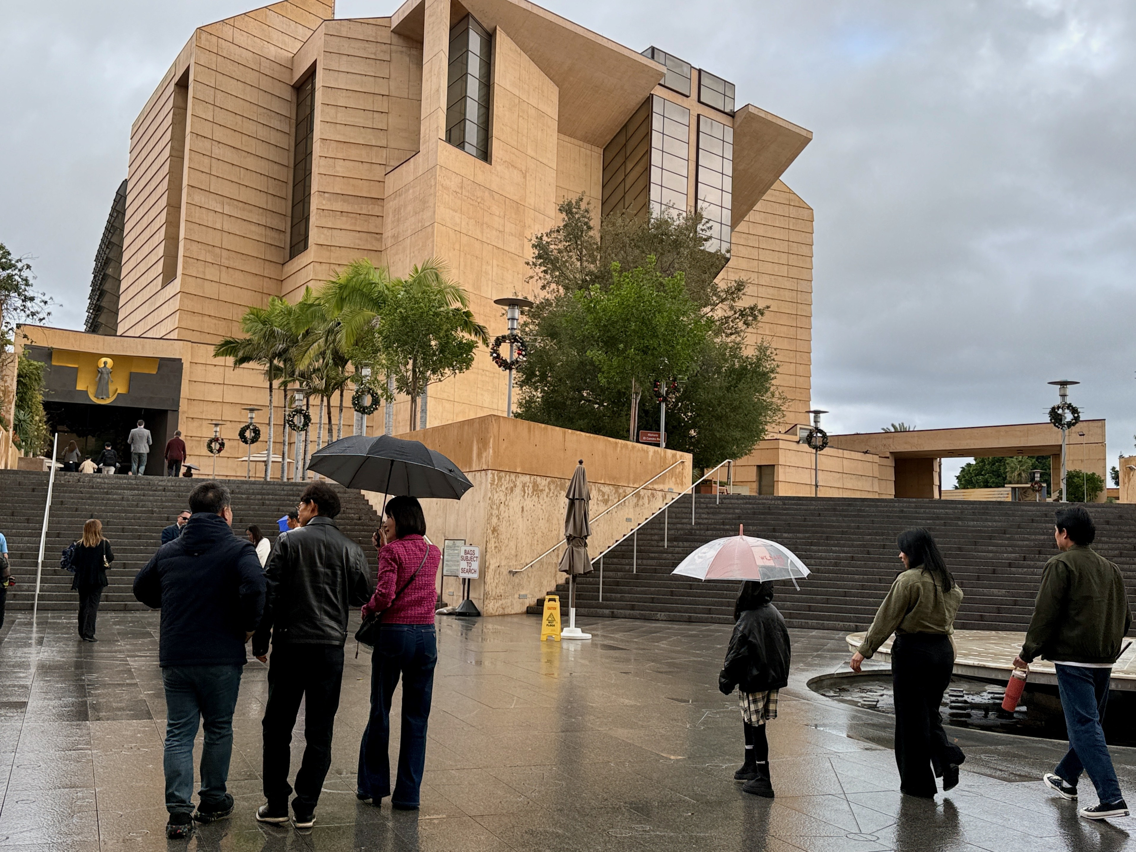 Parishioners enter the Cathedral of Our Lady of the Angels...