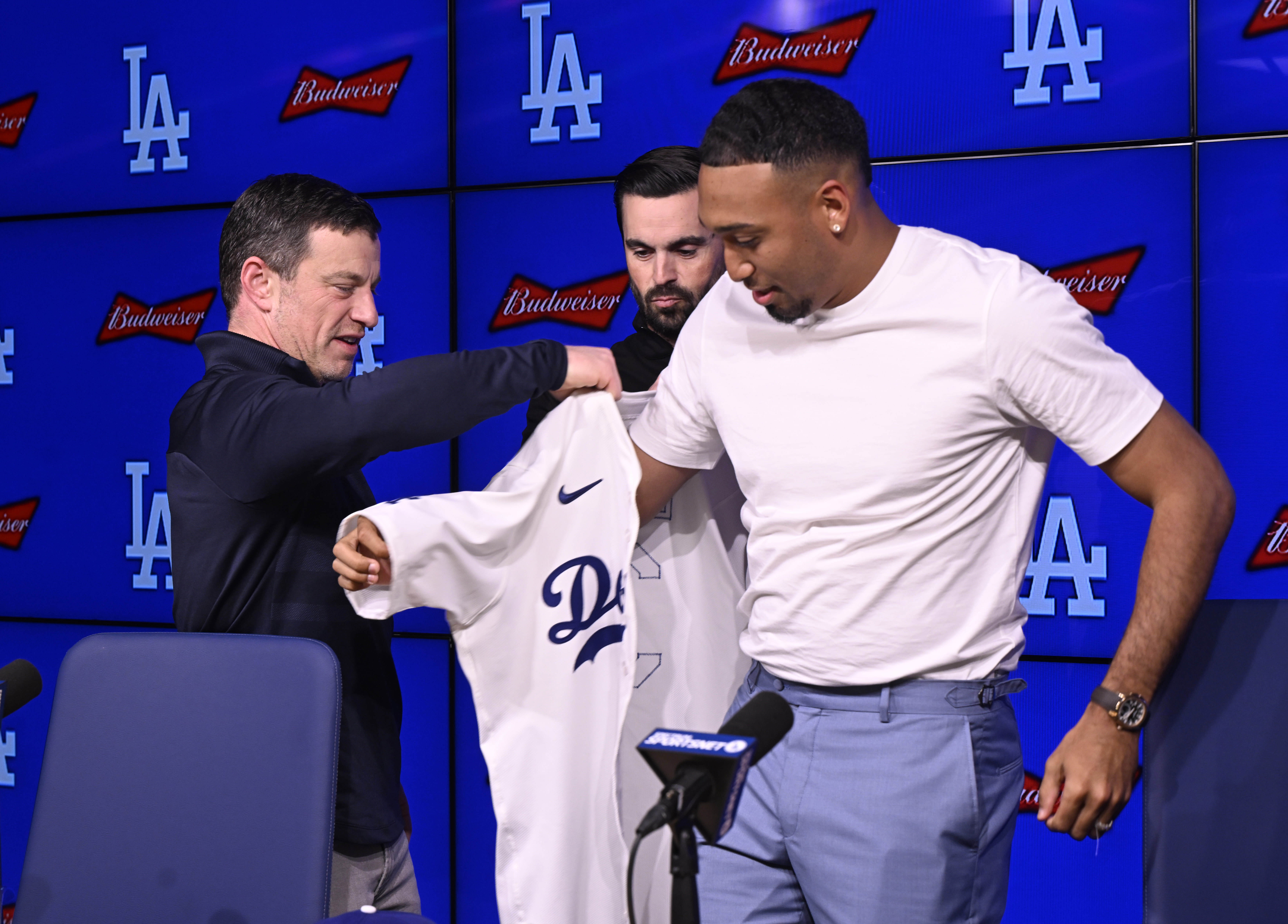 Newly signed Dodgers relief pitcher Edwin Diaz tries on his...
