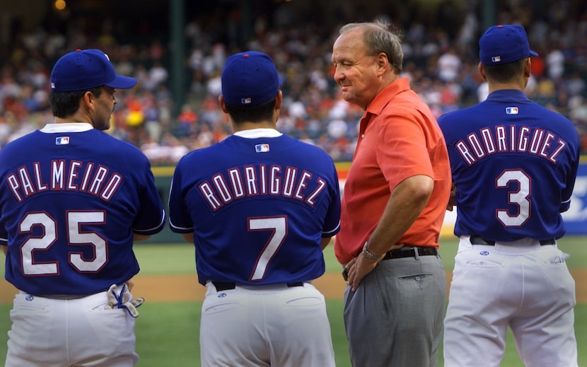 Texas Rangers owner Tom Hicks stands with Rafael Palmeiro, Ivan Rodriguez, and Alex...