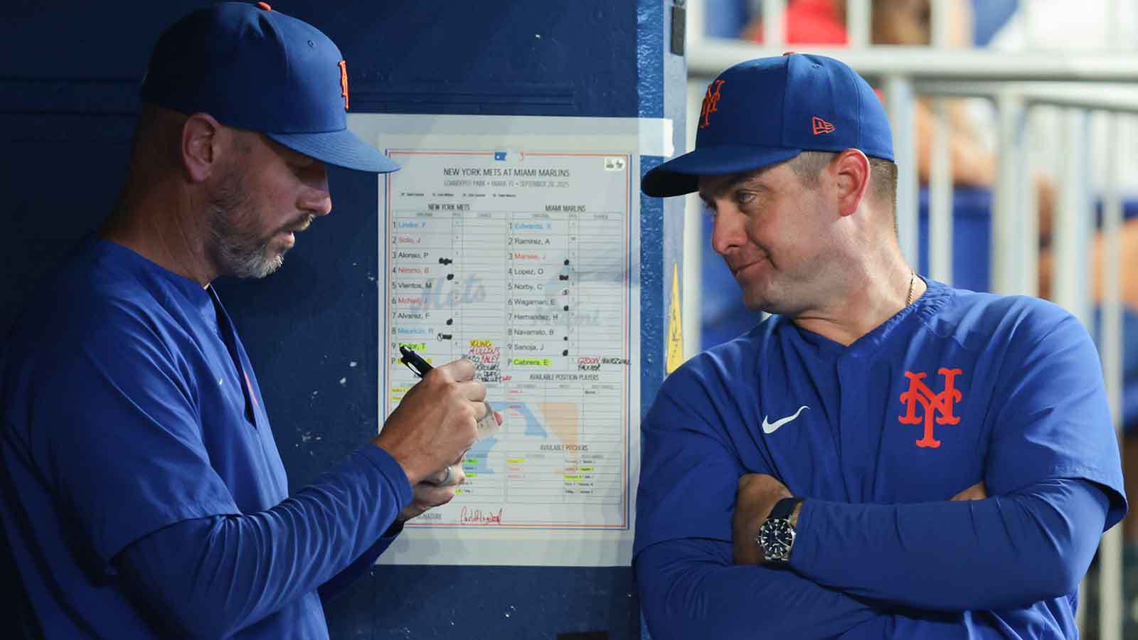 New York Mets manager Carlos Mendoza (64) talks to pitching coach Jeremy Hefner (95) against the Miami Marlins during the eighth inning at loanDepot Park.