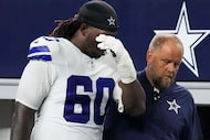 Dallas Cowboys offensive tackle Tyler Guyton (60) leaves the field after being injured...