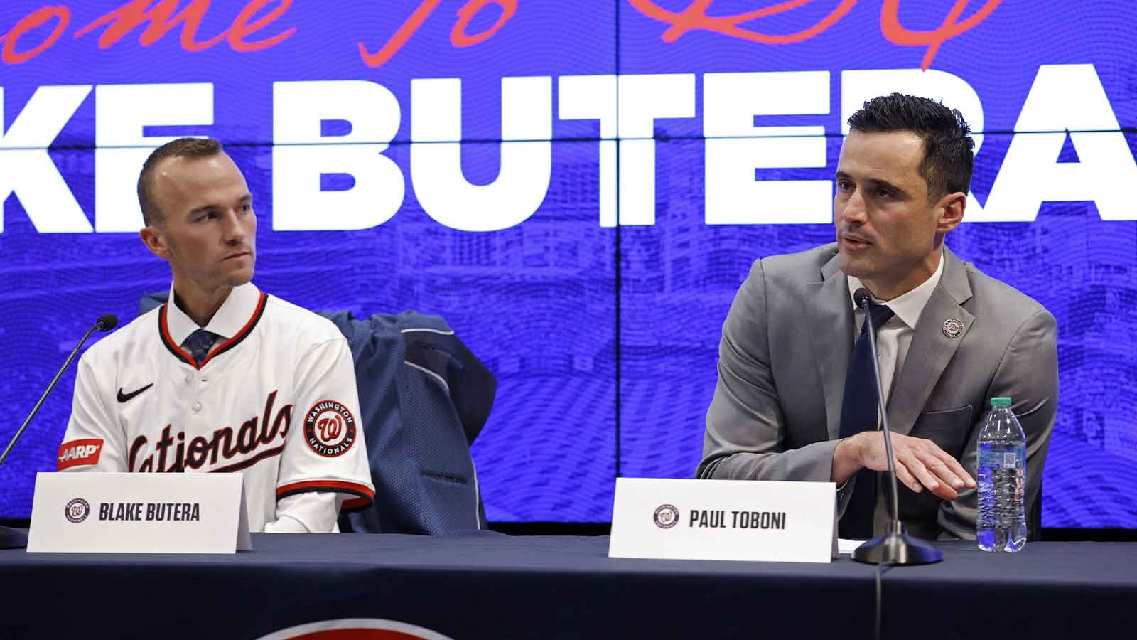 New Washington Nationals manager Blake Butera (L) listens at his introductory press conference as Nationals general manager and president of baseball operations Paul Toboni (R) speaks at Nationals Park.