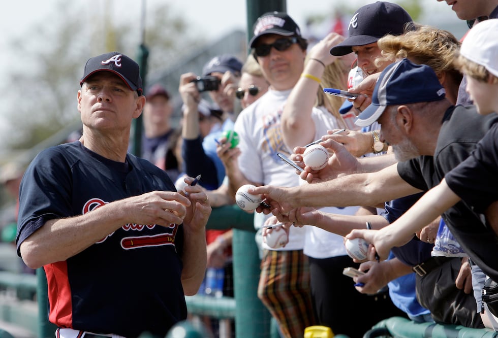 Former Atlanta Braves player Dale Murphy signs autographs before the start of a spring...