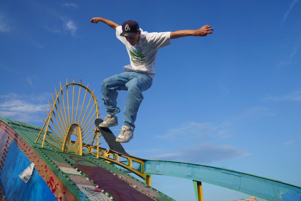 Professional skateboarder Spencer Brown jumps on the upper part of the arch on Howard Street Bridge. Baltimore City, Md.